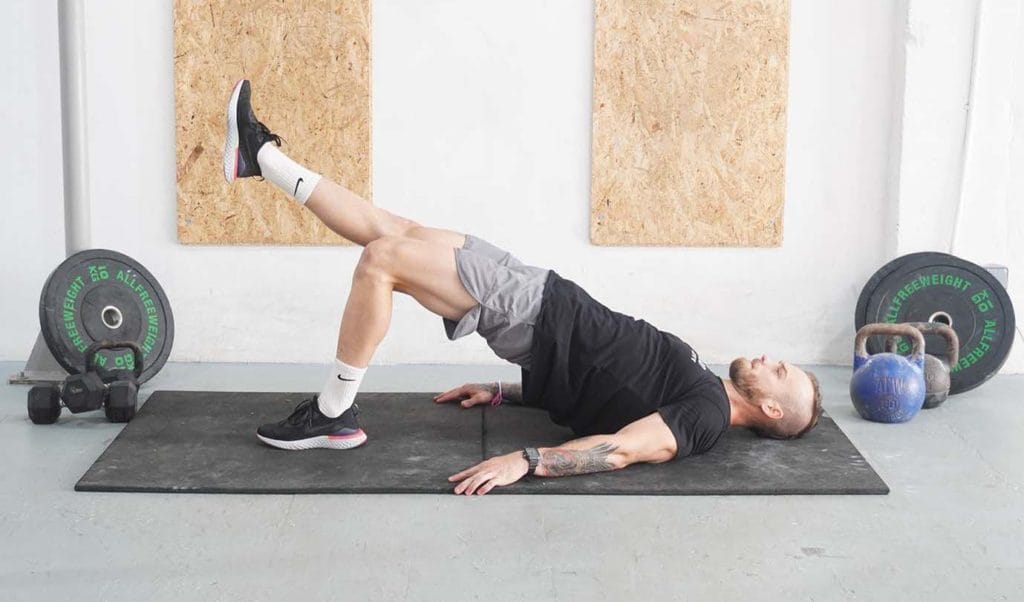 Man is doing Single-Leg Glute Bridge