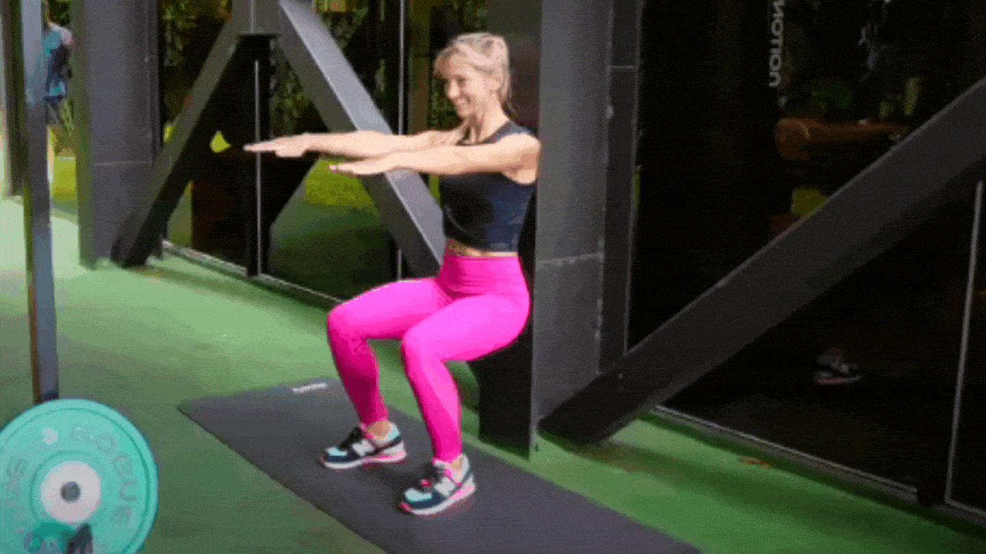 Woman doing Wall Sit with Calf Raise