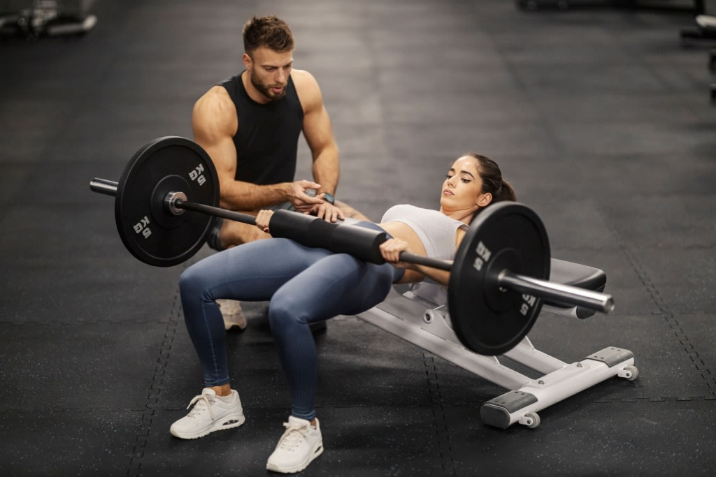 Woman doing Hip Thrust with Barbell