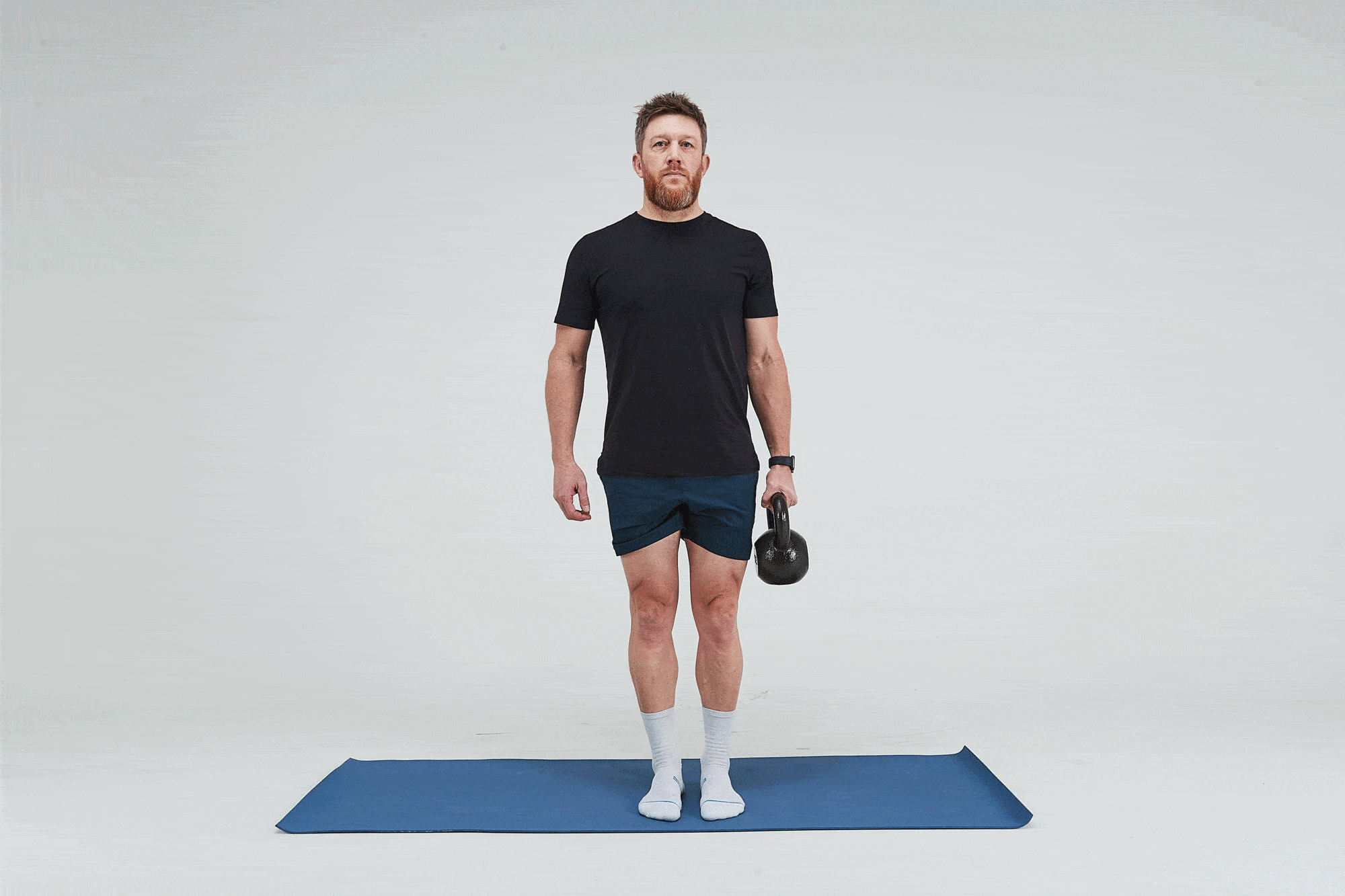 Man doing Kettlebell Suitcase March