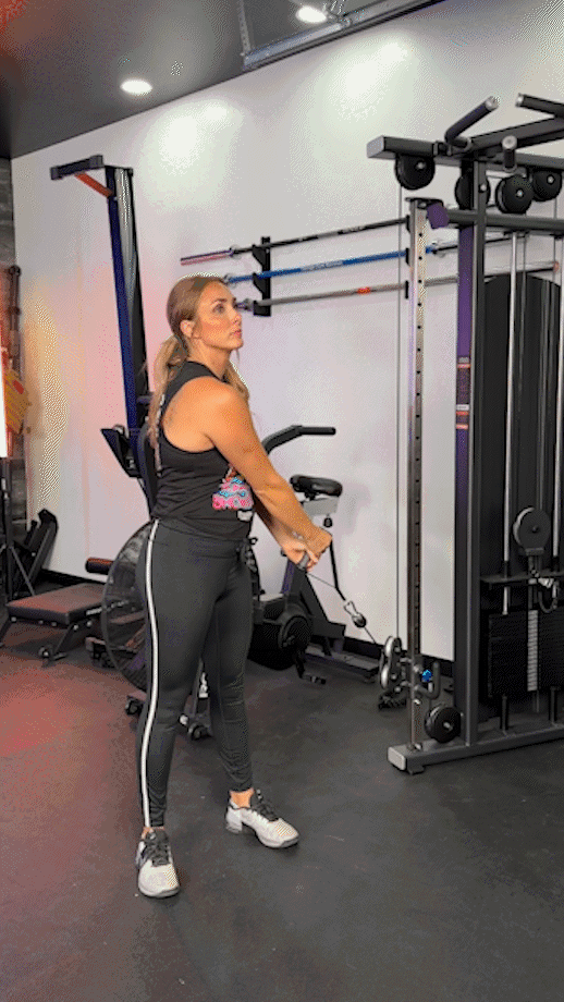 Woman doing Cable Woodchopper (low to high)