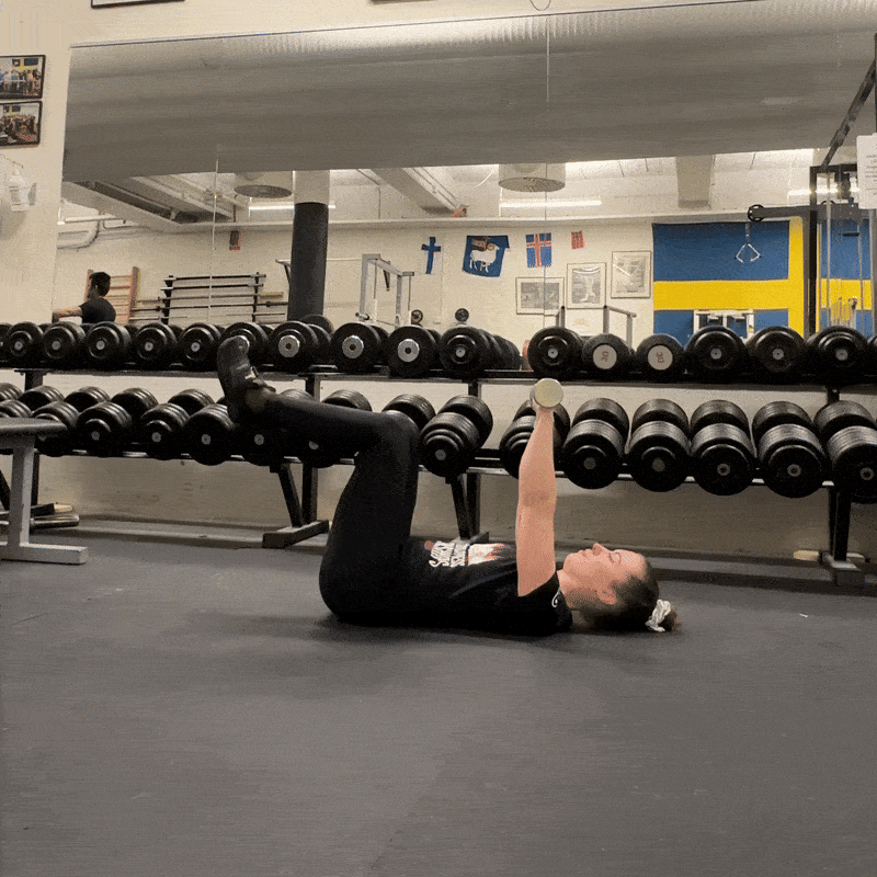 Woman doing Dumbbell Dead Bug Press