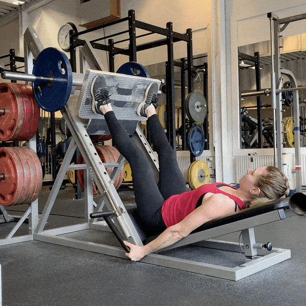 Woman doing Leg Press with Feet High and Wide