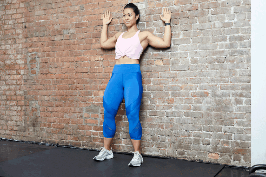 Woman doing Scapular Wall Slides