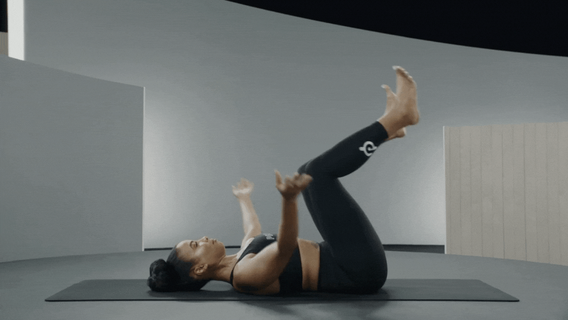 Woman is doing Happy Baby Pose